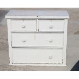 A painted pine chest of two short and two long drawers