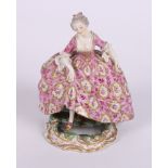 A Sevres porcelain figure of a woman in period costume stepping over a puddle, 5" high (mirror