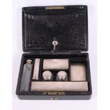 A gentleman's black leather travelling vanity case fitted silver mounted cut glass accessories