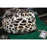 A leopard skin muff with 9ct gold chain