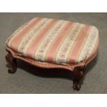 A Victorian carved walnut footstool, upholstered in a striped fabric, on cabriole supports