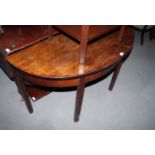 A 19th Century mahogany half round side table, fitted single drop flap, on double gate supports, 45"