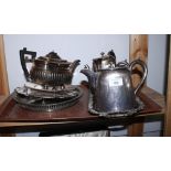 A pierced silver plated bottle coaster with turned wooden base, a silver plated teapot, a plated