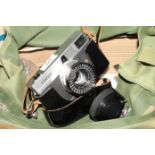 A Ginonet range finder camera with leather ever ready case and a number of filters, etc, in a