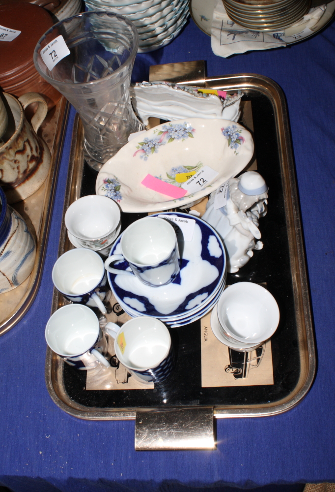 A set of four Limoges porcelain blue and white decorated coffee cans and saucers, a porcelain figure