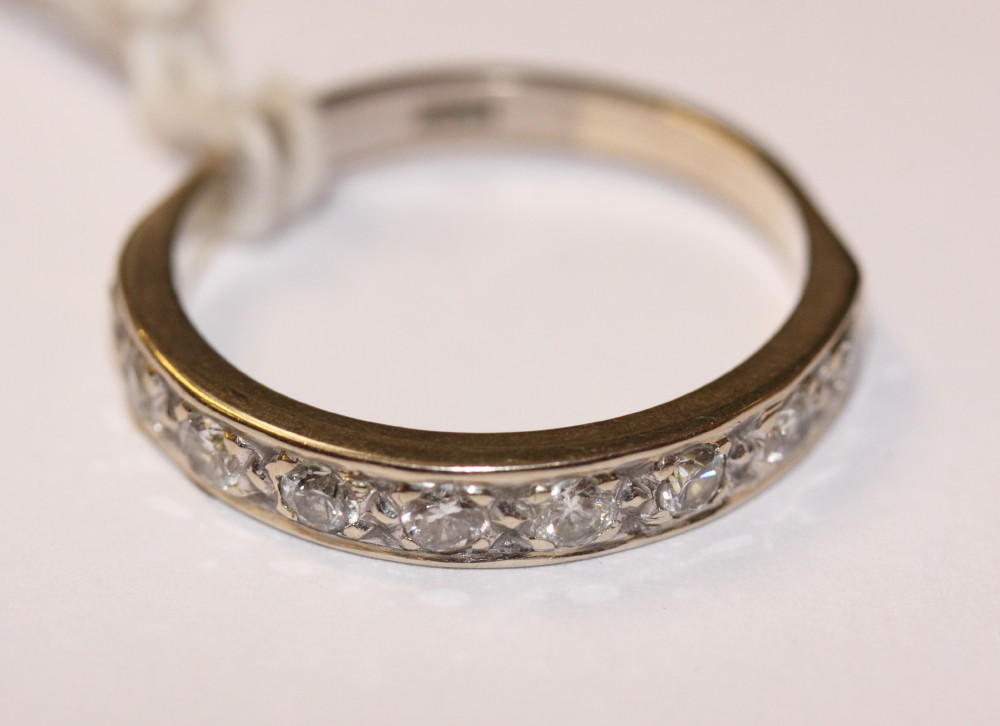 A white metal stamped 18ct and diamond half eternity ring, size Q
