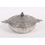 A French pewter fluted dish and cover and a small collection of modern horse brasses, various,