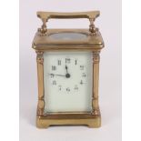 An Edwardian brass cased carriage clock with white enamel dial and Arabic numerals, 4 1/2" high