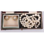 A single string graduated cultured pearl necklace with 14ct white gold diamond chip set clasp, and a