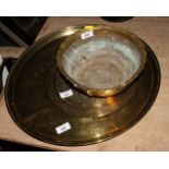 A Middle Eastern engraved brass tray, 19" dia, a smaller similar tray and a companion bowl