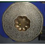 A Middle Eastern embossed brass dish with central well, 31" dia