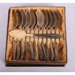 Eleven continental silver teaspoons, 8.2oz troy approx, and an ivory spoon with silver handle