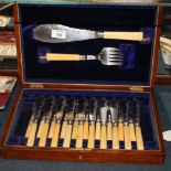 A set of ivory handled fish knives and forks, in oak case