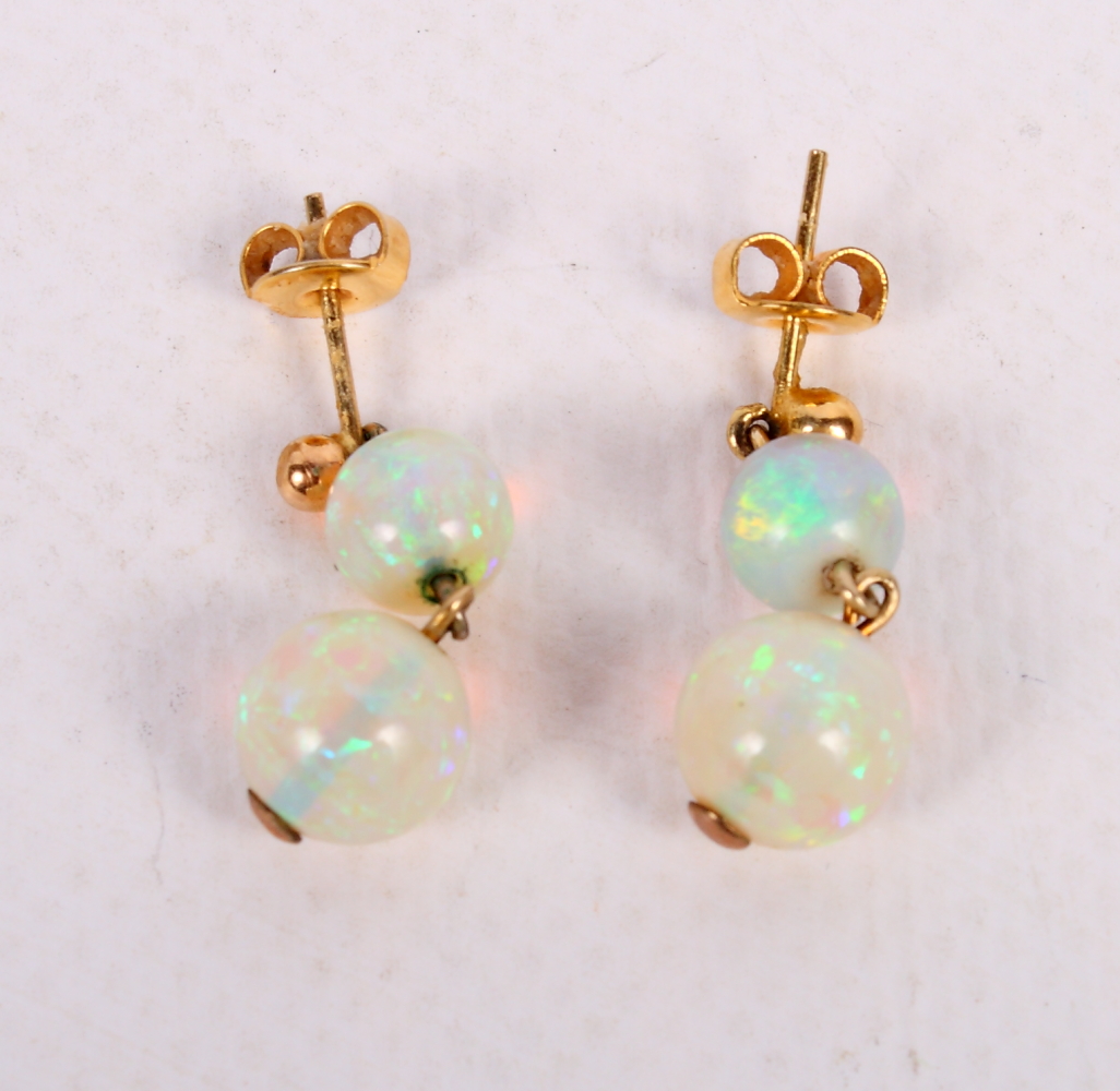 A pair of gold and opal double drop earrings of globular form