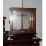 A chemist's brass balance in fitted glass case