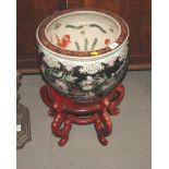 A modern Chinese polychrome fish tank with insect and water lily design, 15" dia, on carved hardwood