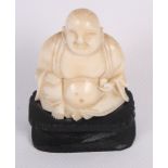 A Chinese carved ivory seated Buddha on hardwood base, 2 3/4" high overall, and a turned ivory and