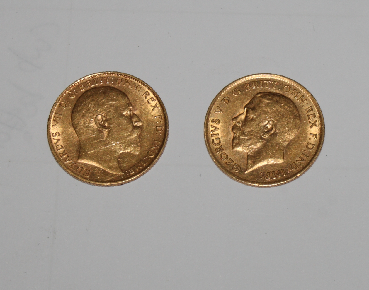 A gold half sovereign dated 1910 and another dated 1912