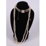 An early 20th Century double string of graduated pearls with white metal, diamond and pearl set