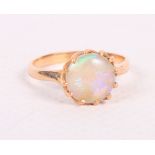 A gold and opal single stone dress ring, size Q