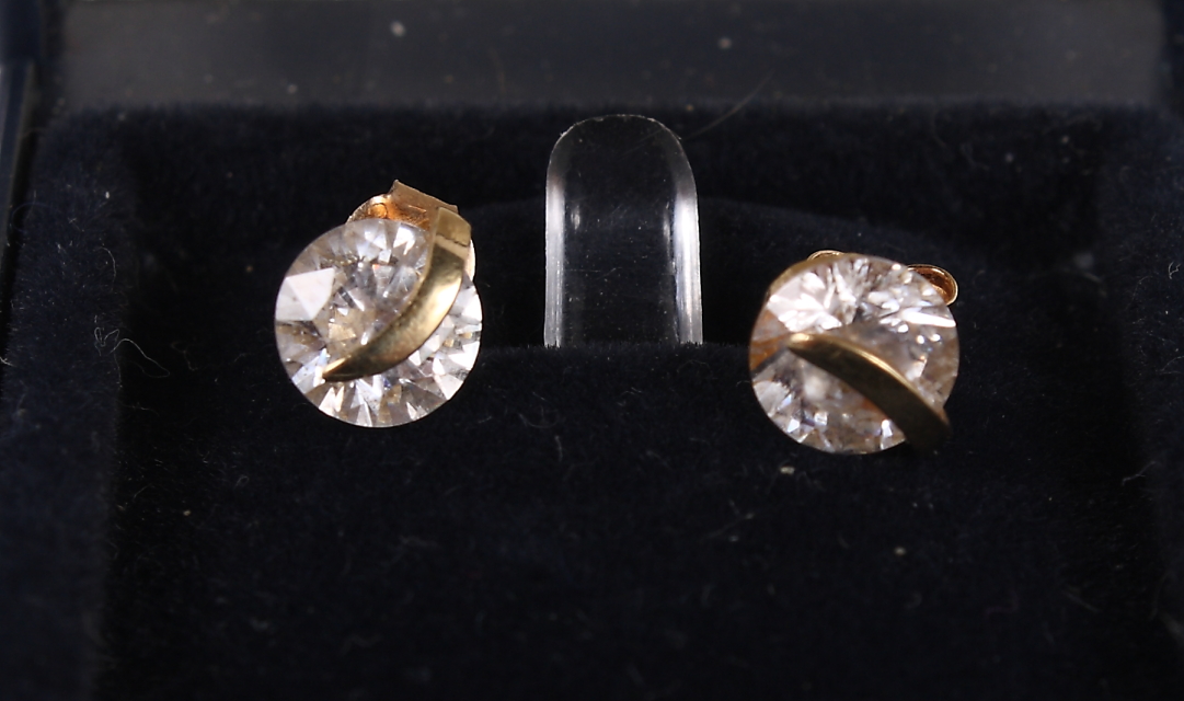 A pair of gold and white gem set earrings