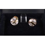 A pair of gold and white gem set earrings