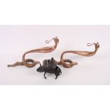 A pair of copper wall mounted hangers in the form of snakes and a miniature bronze censer formed