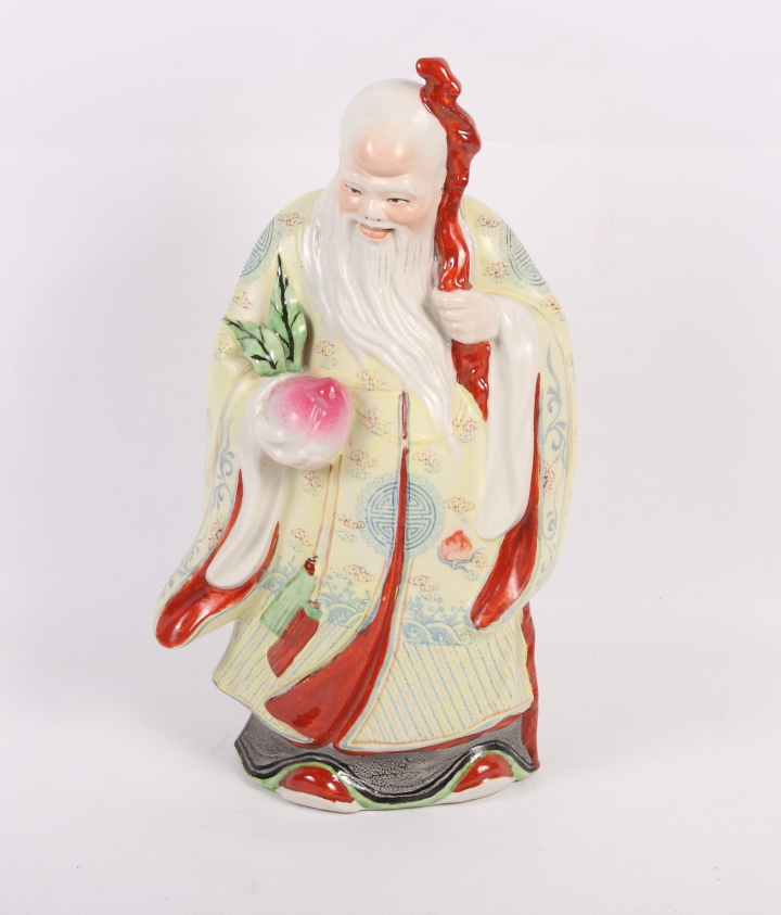 Two pairs of Chinese porcelain pot lids and a Chinese porcelain figure of an elder holding a peach