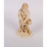 A Japanese carved ivory okimono of a young fisherman, 5 1/2" high