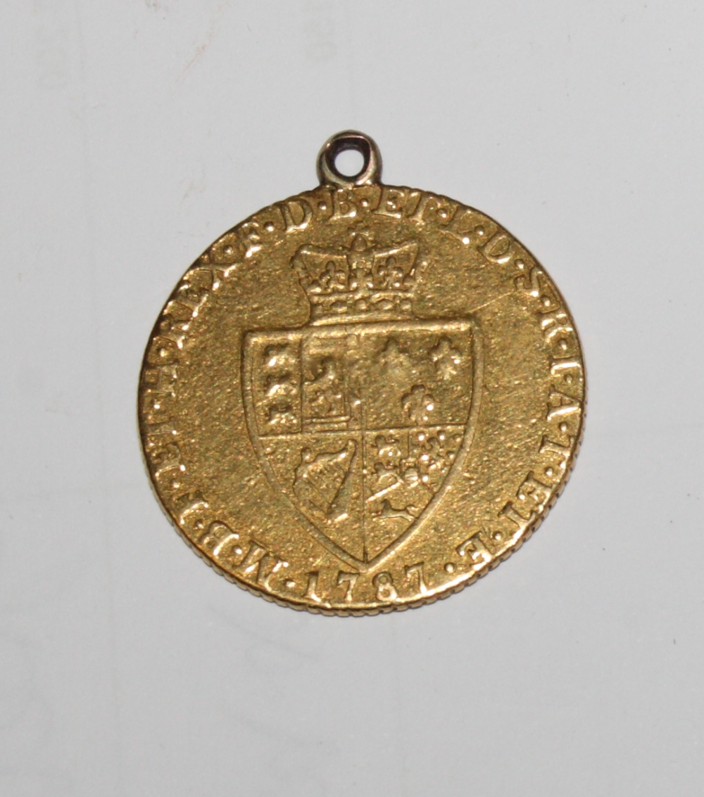 A George III gold guinea dated 1787 (hard mounted)