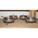 A set of four Victorian silver salts with gadrooned borders and embossed decoration, London 1858,