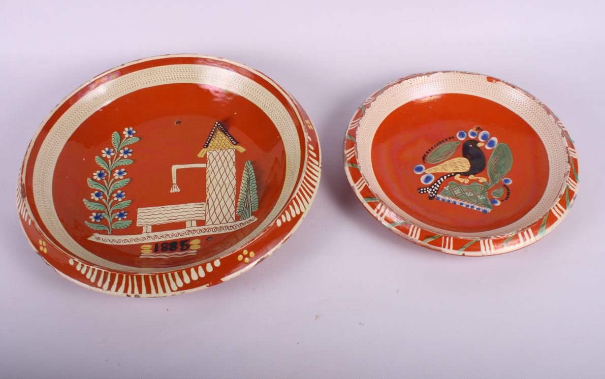 Two 19th Century continental terracotta slip decorated shallow dishes, largest 12" dia (drilled