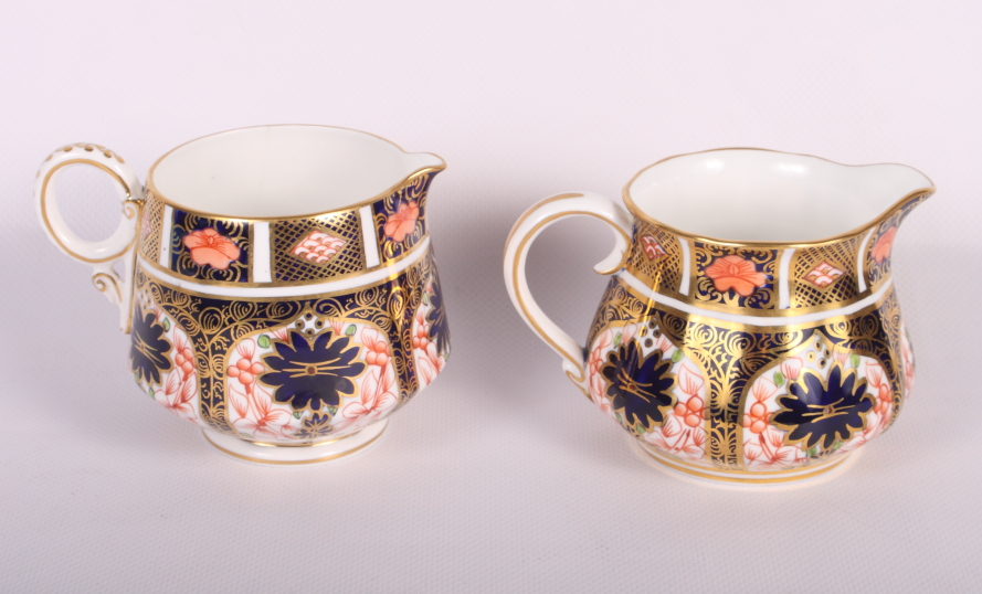 A Royal Crown Derby cream jug, pattern 1128, 3" high, and a similar cream jug