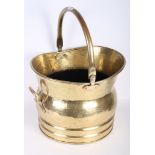 A brass helmet shaped coal scuttle