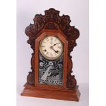 An American carved walnut cased shelf clock and two oak mantel clocks