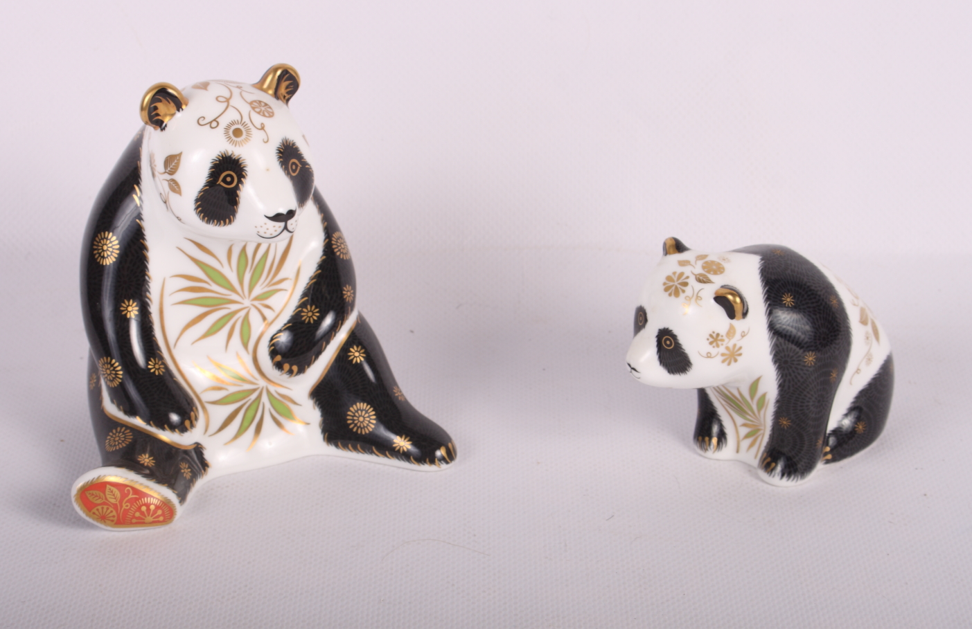 Two Crown Derby gold stopper paperweights, Giant Panda and Baby Panda