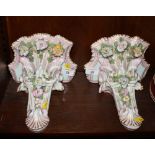 A pair of late 19th Century Dresden floral decorated wall brackets, 9" high (damages)