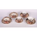 A pair of Crown Derby teacups and saucers, pattern 2451, two similar coffee cups and saucers and a