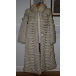 A "Saga Fox" white fox fur full length coat