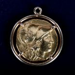 An ancient Greek gold stater coin in a gold pendant mount