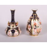 A Royal Crown Derby bottle-shaped two-handled vase with slender neck, pattern 1128, 4 1/2" high, and