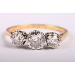 A gold, platinum and diamond three-stone dress ring, central stone .90 carat approx, size Q