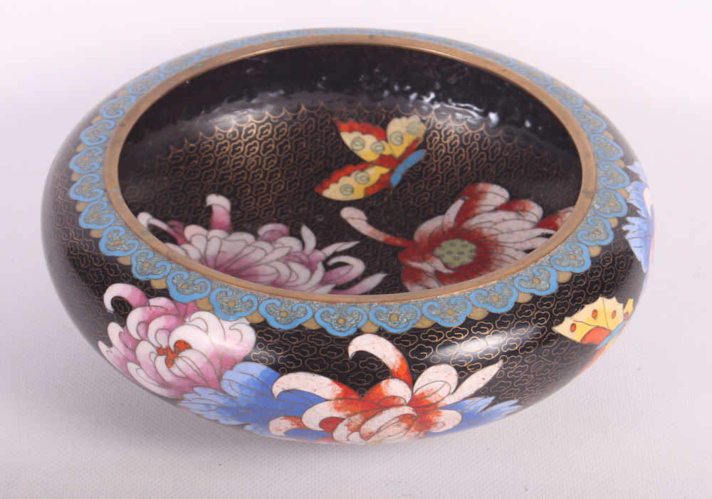 An oriental red lacquered cylindrical workbox and a shallow cloisonne bowl decorated flowers on a