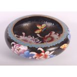 An oriental red lacquered cylindrical workbox and a shallow cloisonne bowl decorated flowers on a