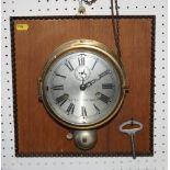 A Seth Thomas brass cased "bulkhead" clock with alarm, 7" dia