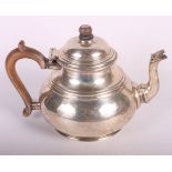 A silver bulbous teapot with wooden handle, 24.1oz troy approx