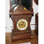 A 19th Century oak cased mantel clock with ivorine chapter ring and eight-day striking movement, 18"