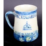 A Moorcroft mug designed by Liberty to commemorate the 1902 Coronation of King Edward VII, 4" high
