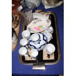 A set of four Limoges porcelain blue and white decorated coffee cans and saucers, a porcelain figure