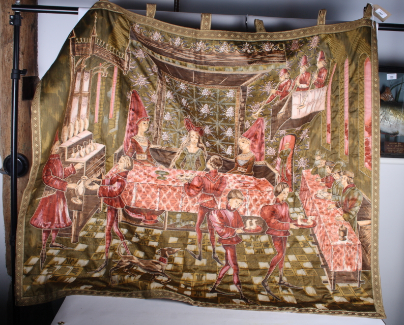 A printed wall hanging decorated medieval banqueting scene, embellished with metal thread, 40" x